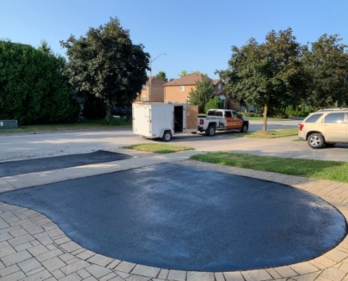 Image depicts a residential driveway that has been sealed.