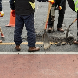 Image depicts our experts repairing asphalt in a driveway.
