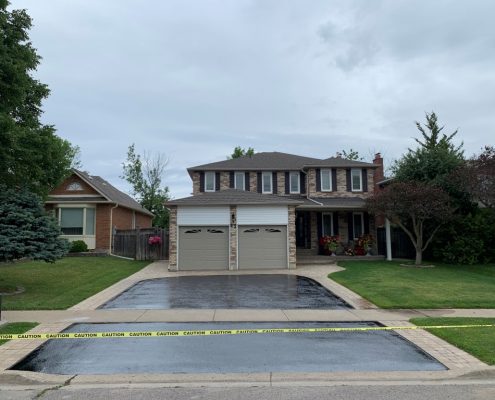 Image depicts a Richmond Hill home with a driveway that has been sealed.