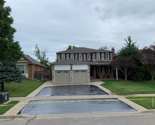 Image depicts a Richmond Hill home with a driveway that has been sealed.