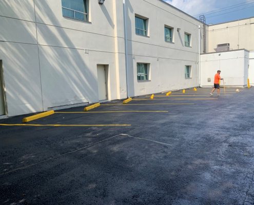 Image depicts a commercial parking lot with newly painted traffic lines.