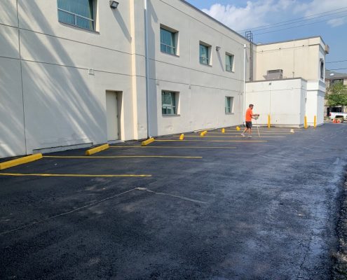 Image depicts a commercial parking lot with newly painted traffic lines.