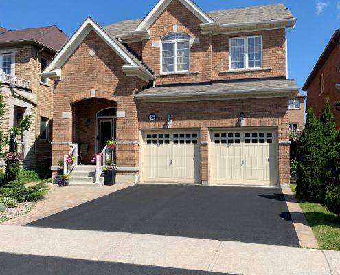 Image depicts a home in Vaughan, Ontario with a driveway that has been sealed.