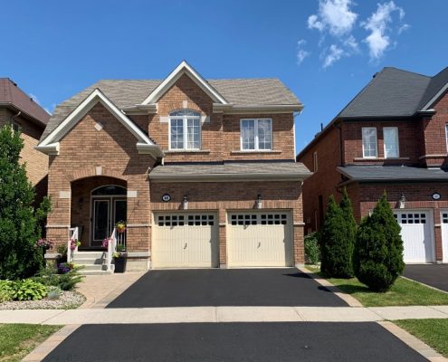 Image depicts a home in Vaughan, Ontario with a driveway that has been sealed.