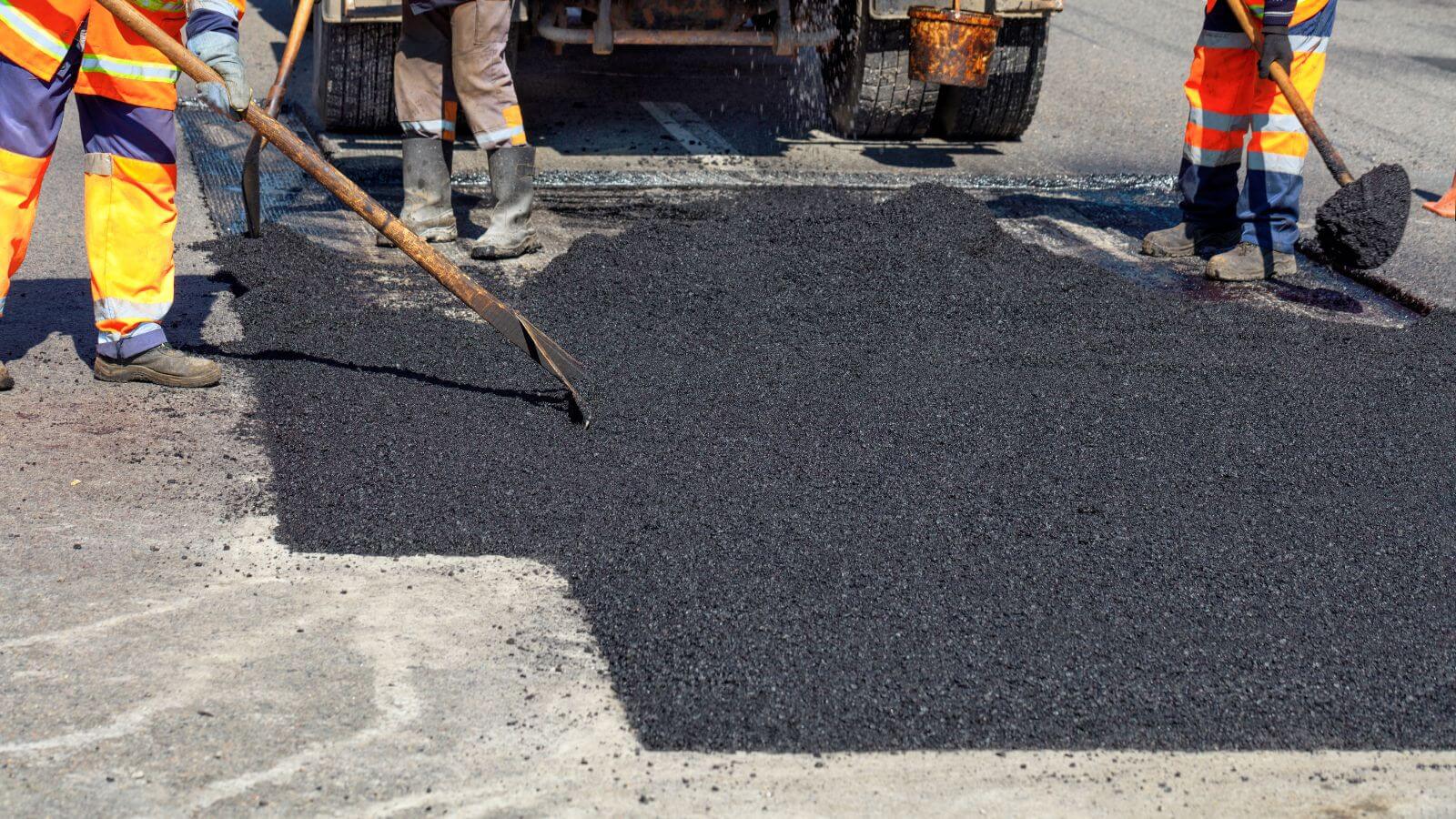 contractors resurfacing crumbling asphalt