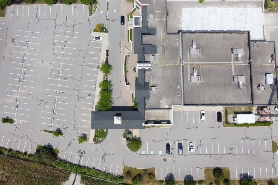 Image depicts an image of a commercial parking lot from a asphalt crack sealing and line painting project by AHS.