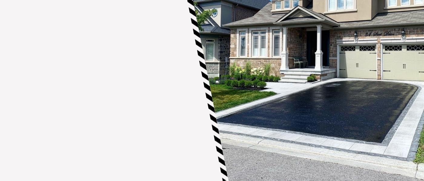 Image depicts a driveway that has been sealed as part of a driveway sealing Ajax project.