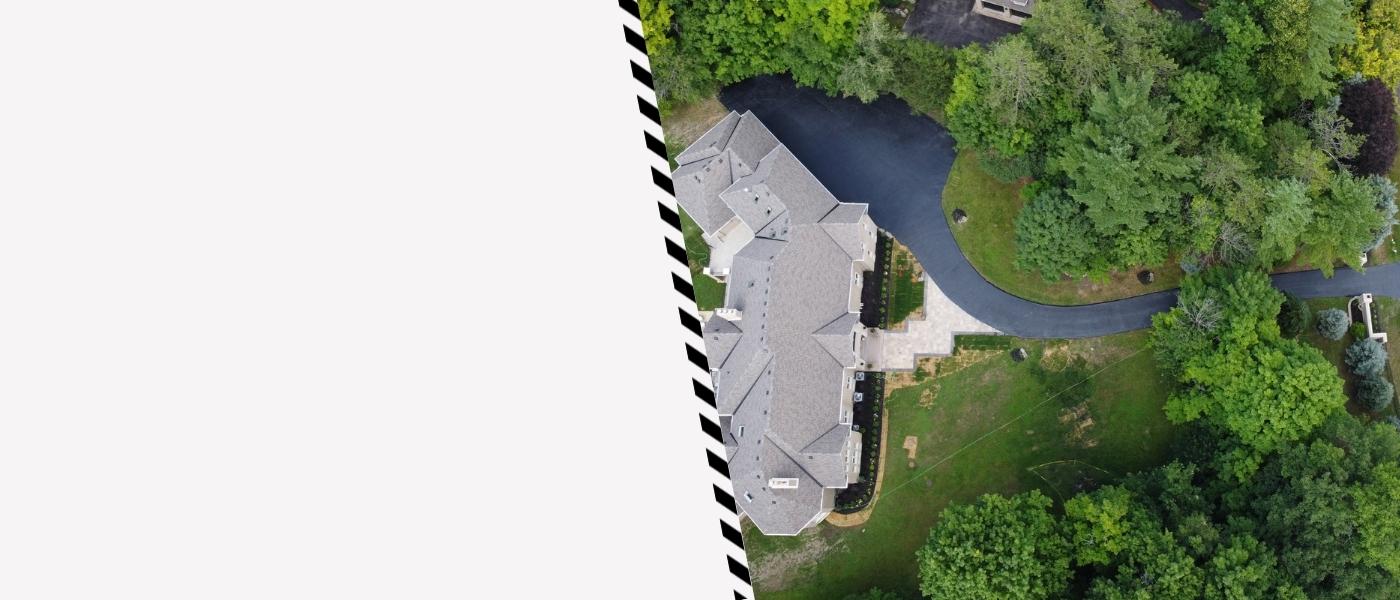 Image depicts a driveway that has been sealed as part of a driveway sealing Aurora project.