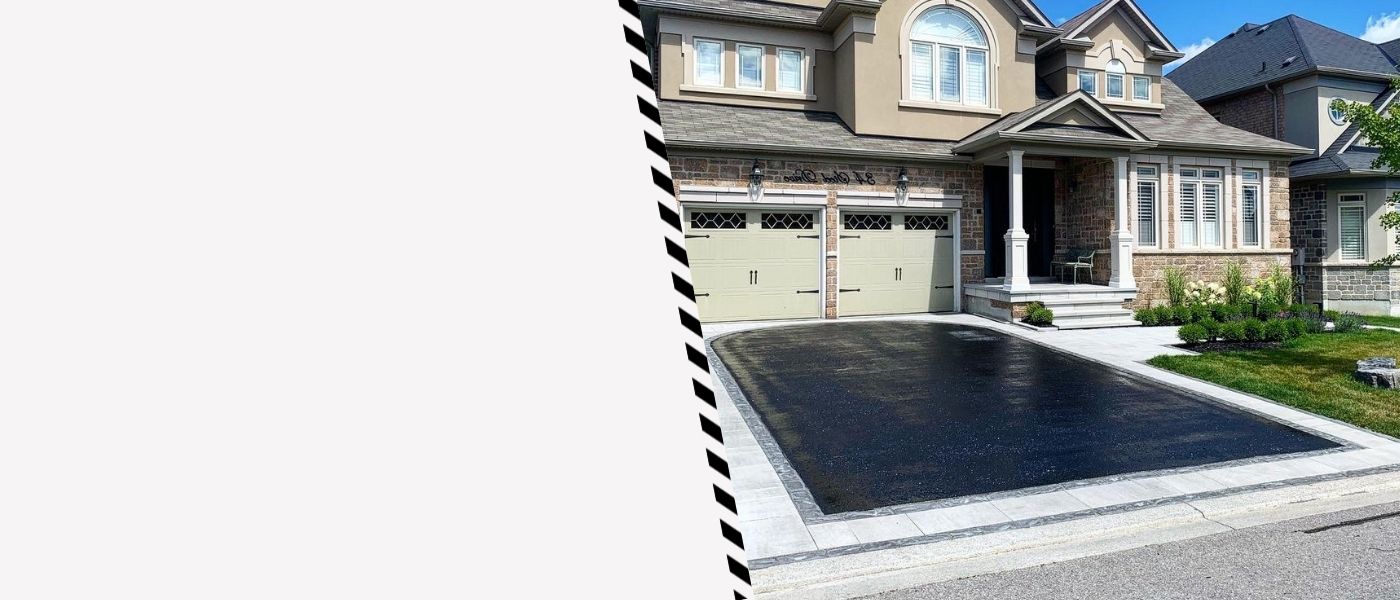 Image depicts a driveway that has been sealed as part of a driveway sealing Maple project.
