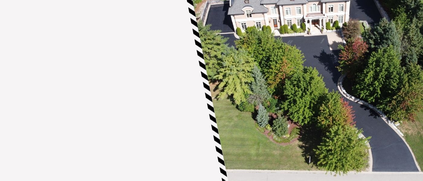 Image depicts a driveway that has been sealed as part of a driveway sealing Milton project.