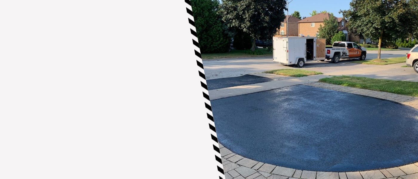 Image depicts a driveway that has been sealed as part of a driveway sealing Oshawa project.