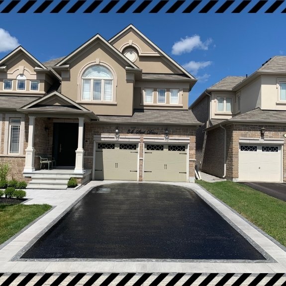 Image depicts a residential driveway as part of a driveway sealing project in Brampton done by AHS.