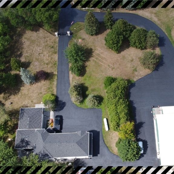 Image depicts a asphalt driveway from a driveway sealing project in Hamilton.