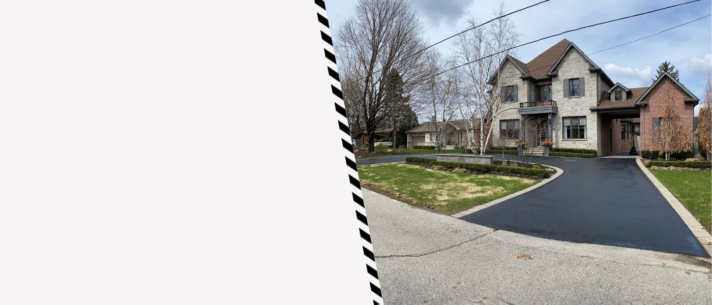 Image depicts a driveway that has been sealed as part of a driveway sealing Stouffville project.
