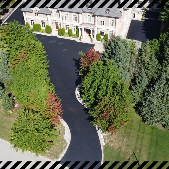 Image depicts a driveway that has been sealed as part of a driveway sealing Unionville project.