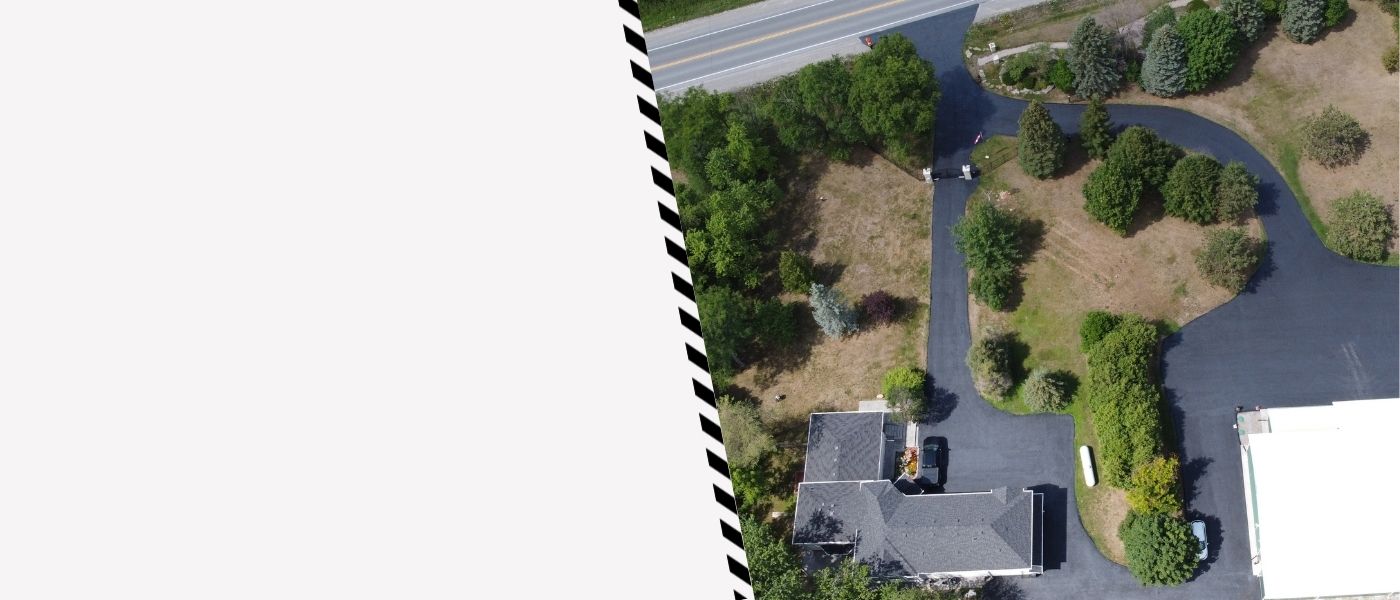 Image depicts a driveway that has been sealed as part of a driveway sealing Uxbridge project.