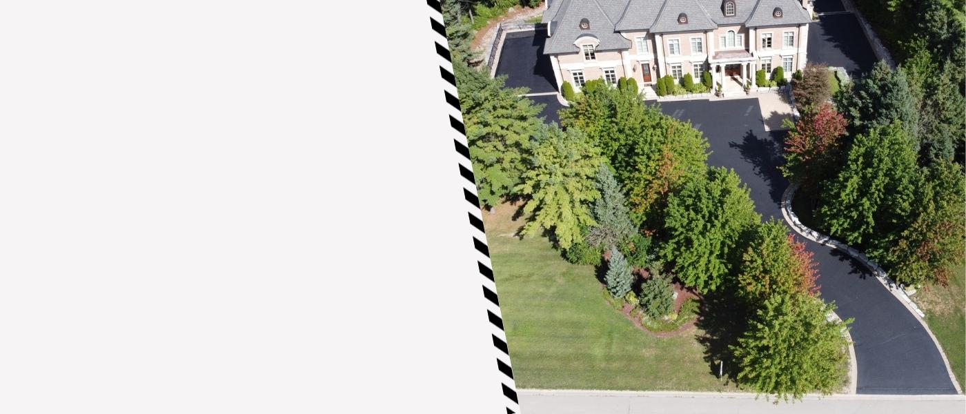 Image depicts a driveway that has been sealed as part of a driveway sealing Whitby project.