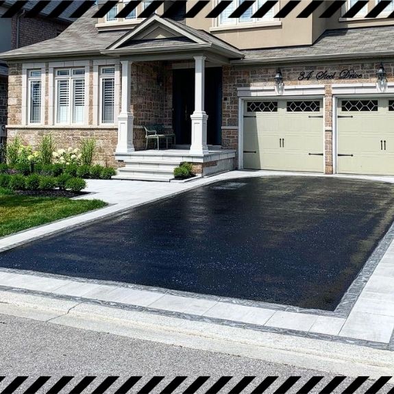 Image depicts a driveway that has been sealed as part of a driveway sealing Etobicoke project.