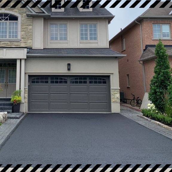 Image depicts a driveway that has been sealed as part of a driveway sealing Keswick project.