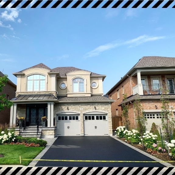 Image depicts a driveway that has been sealed as part of a driveway sealing King City project.