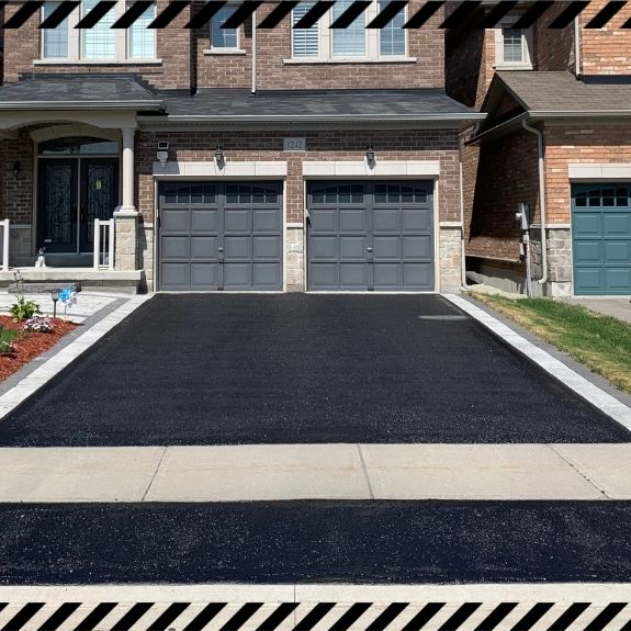 Image depicts a driveway that has been sealed as part of a driveway sealing Georgetown project.