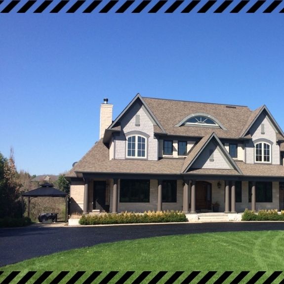 Image depicts a driveway that has been sealed as part of a driveway sealing Ajax project.