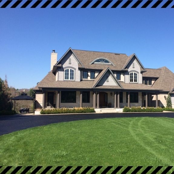 Image depicts a driveway that has been sealed as part of a driveway sealing Uxbridge project.