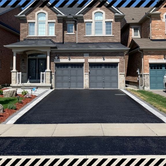 Image depicts a driveway that has been sealed as part of a driveway sealing Burlington project.