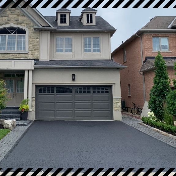 Image depicts a driveway that has been sealed as part of a driveway sealing Caledon project.