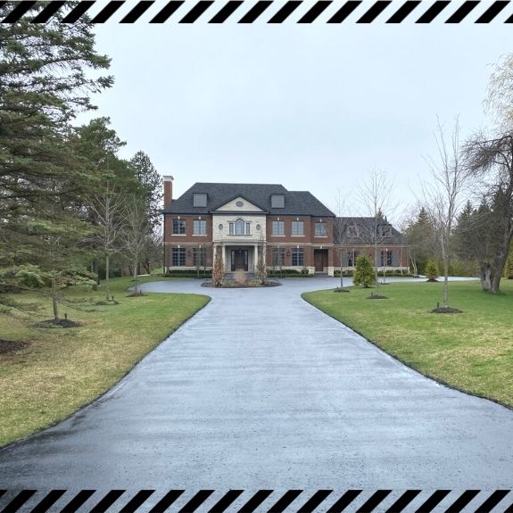 Image depicts a driveway that has been sealed as part of a driveway sealing Concord project.