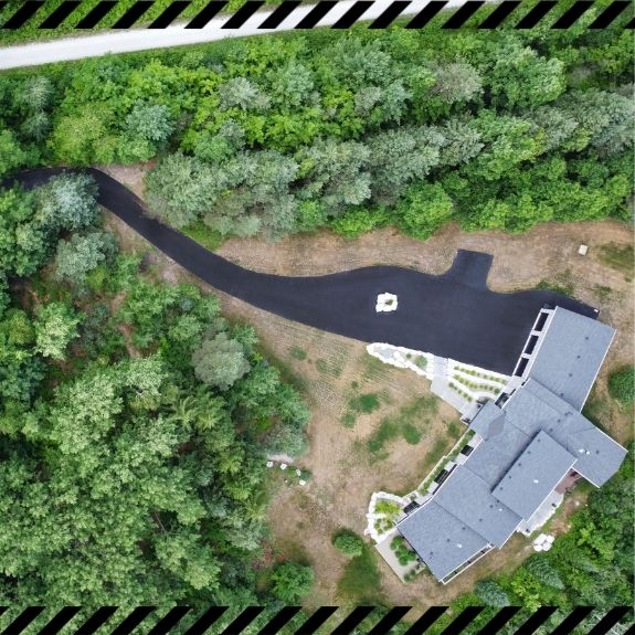 Image depicts a driveway that has been sealed as part of a driveway sealing Whitby project.