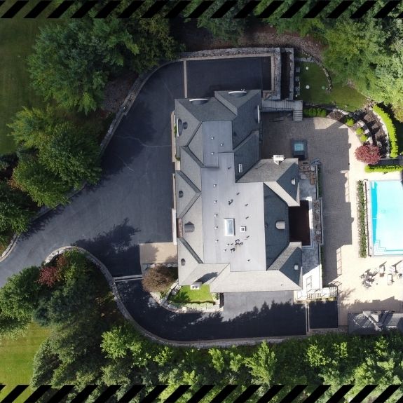 Image depicts a driveway that has been sealed as part of a driveway sealing Woodbridge project.