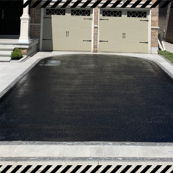 Image depicts a driveway that has been sealed as part of a driveway sealing Pickering project.