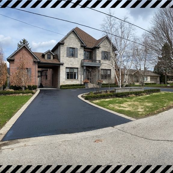 Image depicts a driveway that has been sealed as part of a driveway sealing Aurora project.