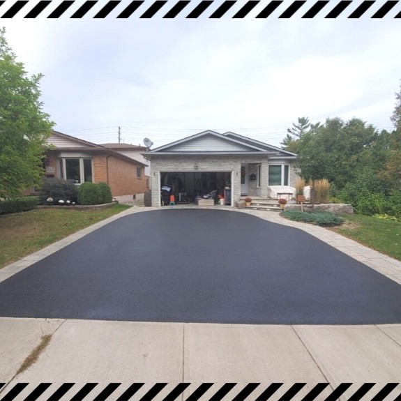 Image depicts a driveway that has been sealed as part of a driveway sealing Bolton project.