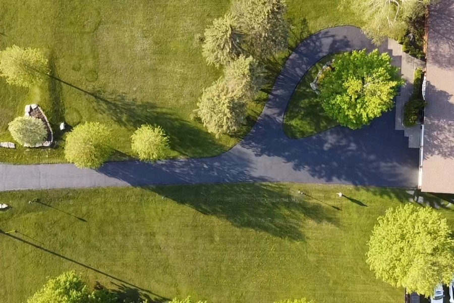 Image depicts a residential driveway from a residential asphalt sealing project in Aurora by AHS.