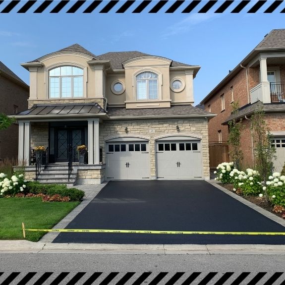 Image depicts a driveway that has been sealed as part of a driveway sealing Stouffville project.