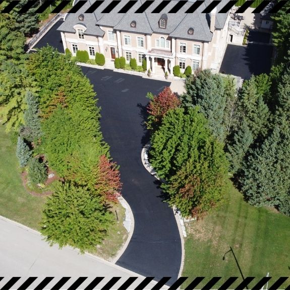 Image depicts a driveway that has been sealed as part of a driveway sealing Thornhill project.
