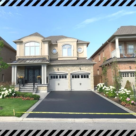 Image depicts a driveway that has been sealed as part of a driveway sealing Toronto project.